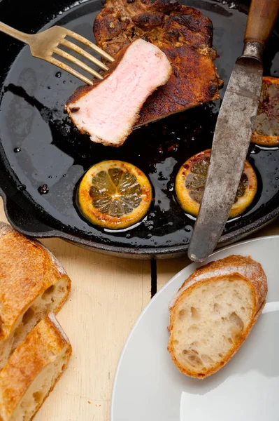 Pork chop seared on iron skillet — Stock Photo, Image