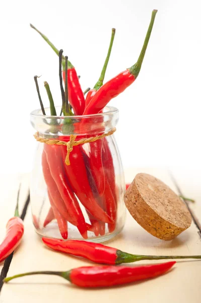 Red chili peppers on a glass jar — Stock Photo, Image