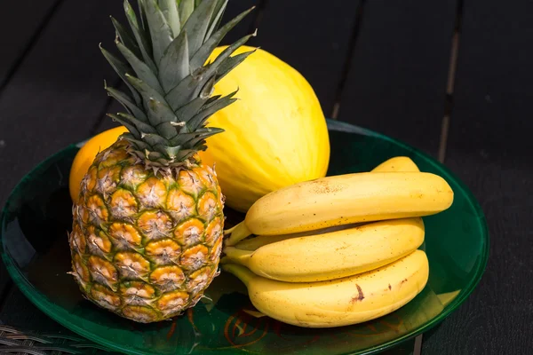 Assortment of fresh exotic fruits on  black table — Stock Photo, Image