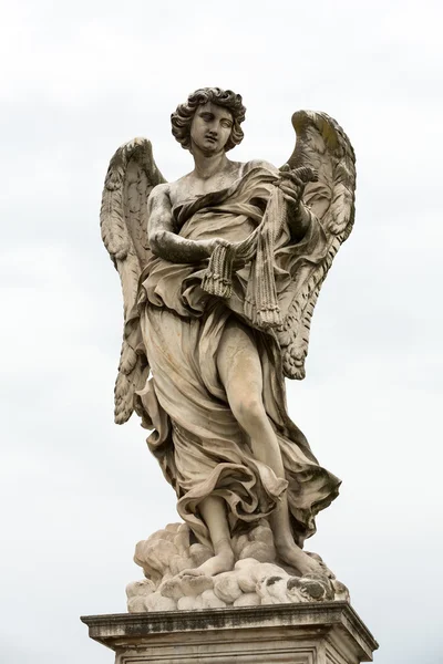 Marble statue of Angel with the Whips by Lazzaro Morelli from the Sant 'Angelo Bridge in Rome, Italy — стоковое фото