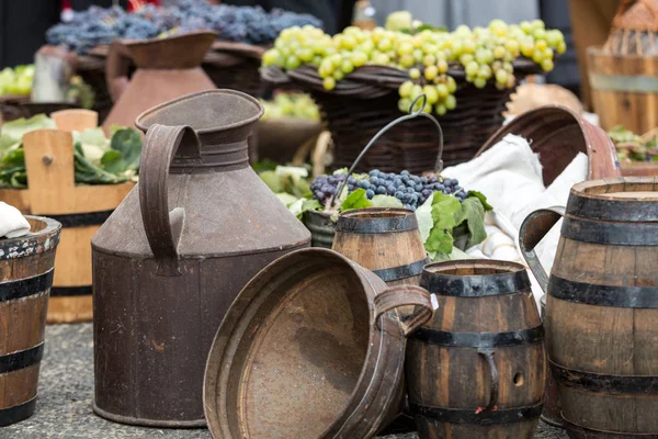 Old barrels and tools for wine production and  baskets with grapes — Stock Photo, Image