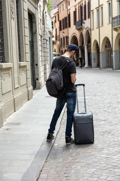 the lost tourist with the suitcase on the street in Padua. Italy