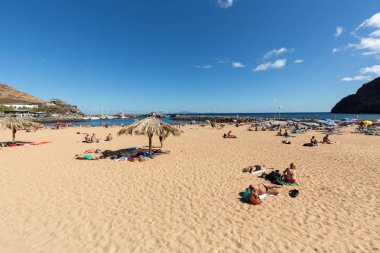 İnsanlar güneşli bir günde Machico plajda dinleniyor. Madeira Adası,