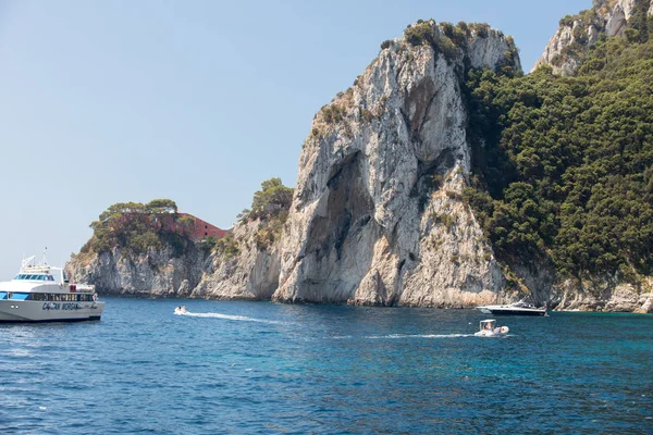 Visa från båten på båtar med turister och ön cliff kusten i Capri. Italien — Stockfoto