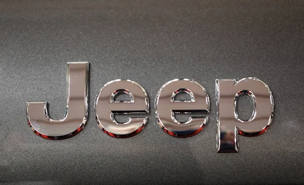 Jeep metallic logo closeup on Jeep car displayed at  MOTO SHOW in Cracow Poland. Exhibitors present  most interesting aspects of the automotive industry — Stock Photo, Image