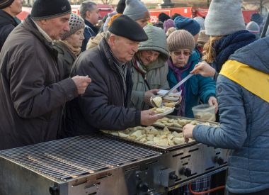 Cracow, Poland - December 17, 2017:   Christmas Eve for poor and homeless on the Main Square in Cracow. Every year the group Kosciuszko prepares the greatest eve in the open air in Cracow. Poland clipart