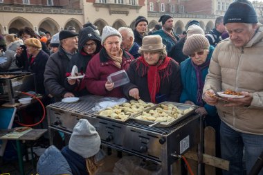 Krakov, Polonya - 17 Aralık 2017: Noel arifesi yoksul ve Cracow ana meydanında evsizlere için. Her yıl grup Kosciuszko Cracow açık havada büyük eve hazırlar. Polonya