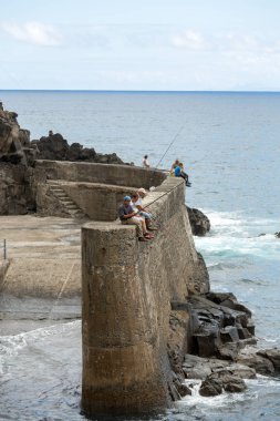 Porto da Cruz, Madeira, Portekiz - 11 Eylül 2016: Porto da Cruz Madeira dalgakıran üzerinde cesur için sadece Balık tutma. Portekiz