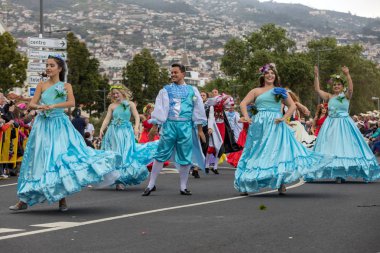 Funchal; Madeira; Portekiz - 22 Nisan; 2018: bir grup insan renkli kostümleri dans Madeira çiçek Festivali geçit töreninde Funchal, Madeira Adası üzerinde. Portekiz.
