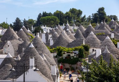 Alberobello, İtalya - 16 Eylül 2019: Trulli köyünde geleneksel beyaz evler. Alberobello, İtalya. Yapım tarzı İtalya 'nın Apulia bölgesindeki Murge bölgesine özgüdür (İtalyan Puglia bölgesinde). Kireç taşı ve temel taştan yapılmış..