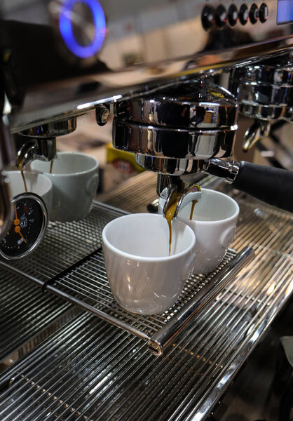 Cracow, Poland - November 20, 2019:  Barista making coffee at coffee machine at Gastrofood - Trade Fair for Food and Drinks for Catering in Cracow. Poland
