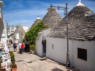 Alberobello, İtalya - 16 Eylül 2019: Halk Alberobello, İtalya 'daki Trulli köyünü ziyaret etti. Yapım tarzı İtalya 'nın Apulia bölgesindeki Murge bölgesine özgüdür (İtalyan Puglia bölgesinde). Kireç taşı ve temel taştan yapılmış..