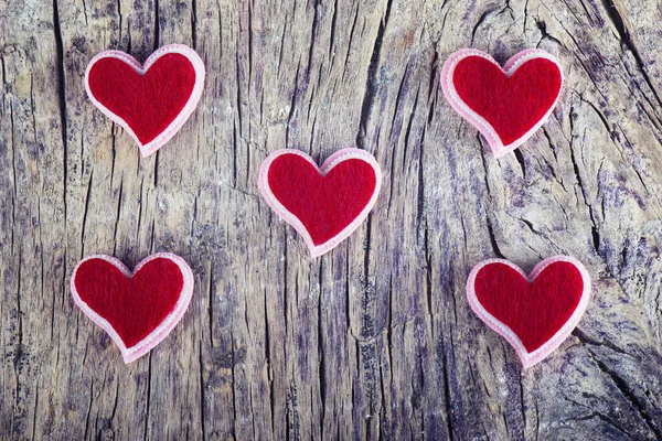 Corazones rojos sobre madera texturizada — Foto de Stock