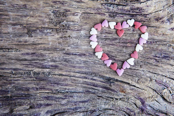 Tiny hearts on old wood — Stock Photo, Image