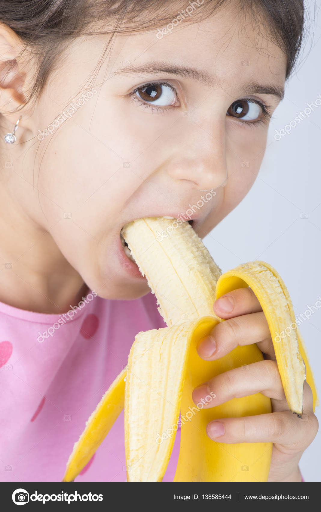 child eating banana