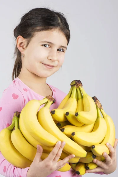 Happy girl holding banana — Stock Photo, Image
