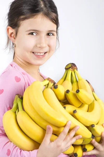 Cute girl holding fresh bananas — Stock Photo, Image