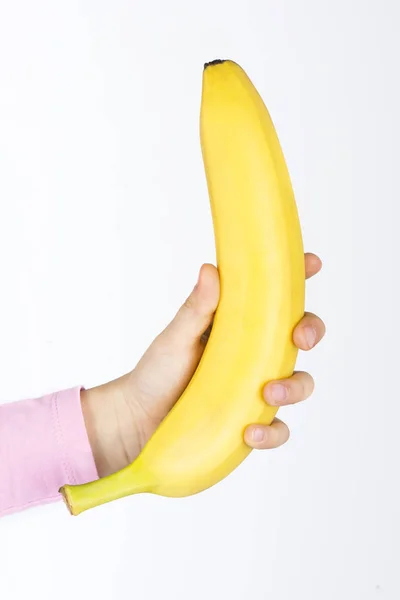 Banan i hånden. – stockfoto