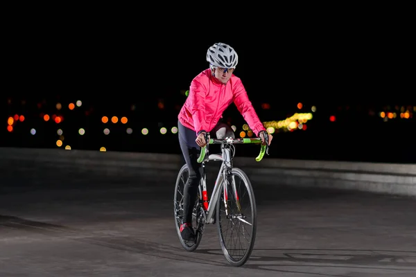 Woman Cyclist Riding Road Bike at Night in the City. Healthy Lifestyle and Urban Sport Concept — Stock Photo, Image