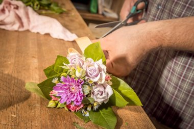yakın çekim adam kesme çiçek çiçekçi makasla.