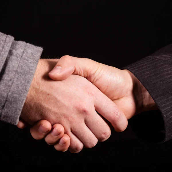 Business handshake su sfondo nero — Foto Stock