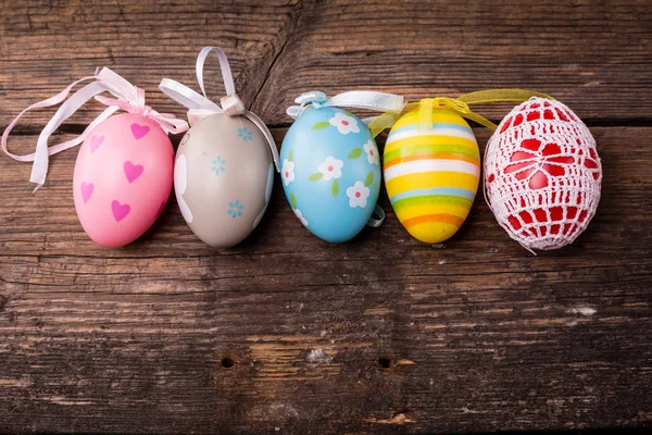 Huevos de Pascua sobre fondo rústico de madera — Foto de Stock