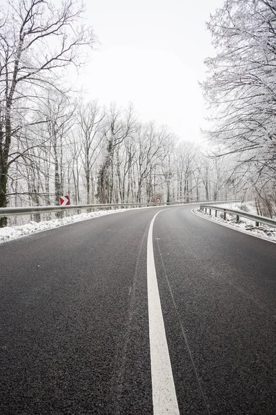 Snowy road at wintertime — Stock Photo, Image