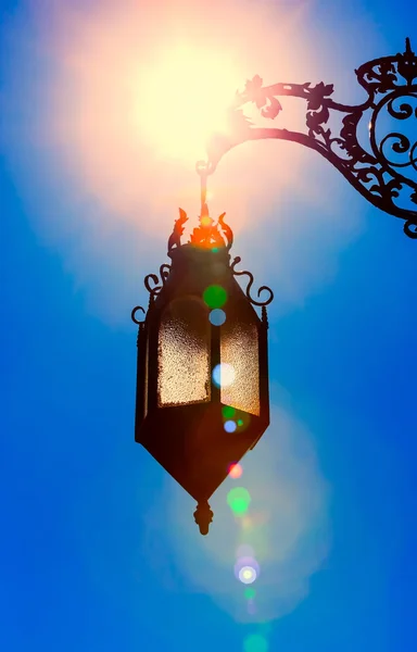 Silhouette of old lantern hanging in bright sunlight — Stock Photo, Image