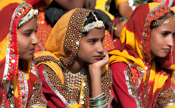 An unidentified girls  in colorful ethnic attire attends at the 