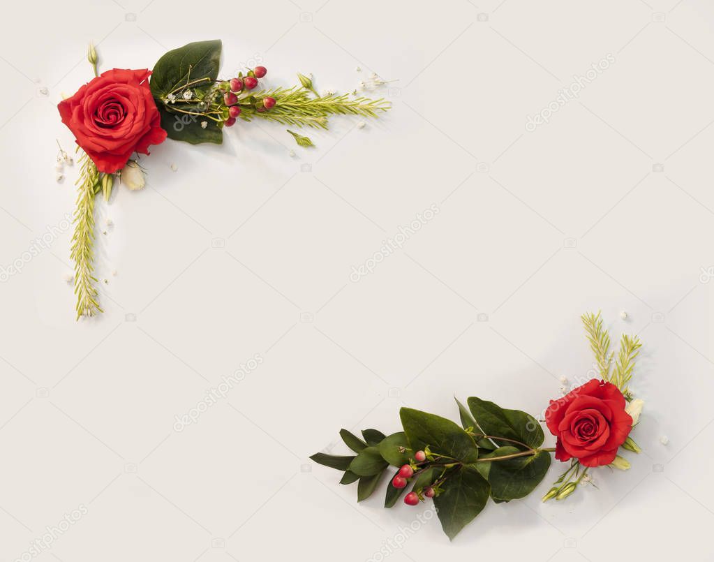 Frame made from flowers with green addons and clean copy space with isolated white background. Top view