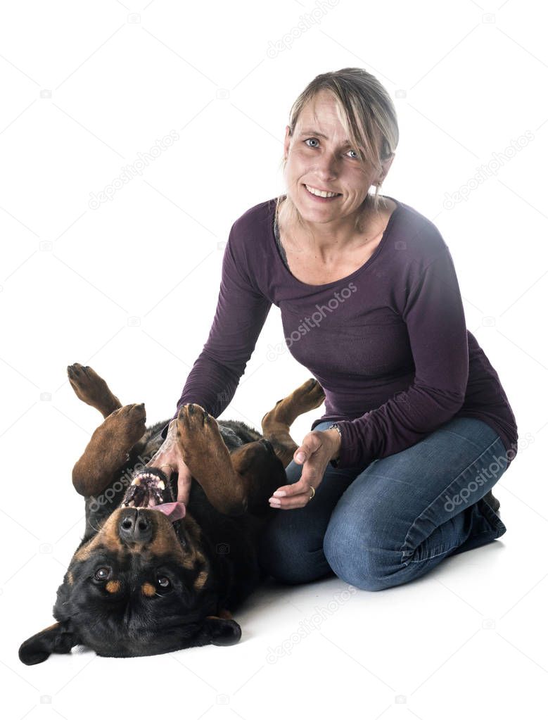 adult rottweiler  and woman in front of white background