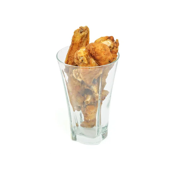 Palitos de pollo frito y alas en un vaso aislado sobre fondo blanco — Foto de Stock