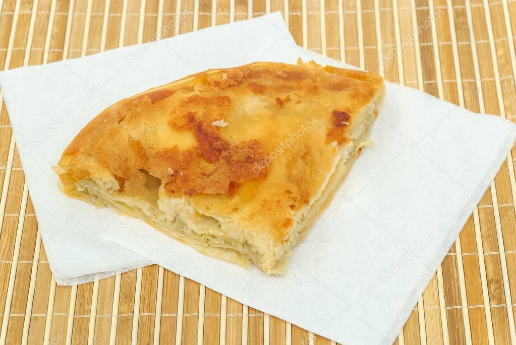  burek or pie with cheese on a paper serviettes