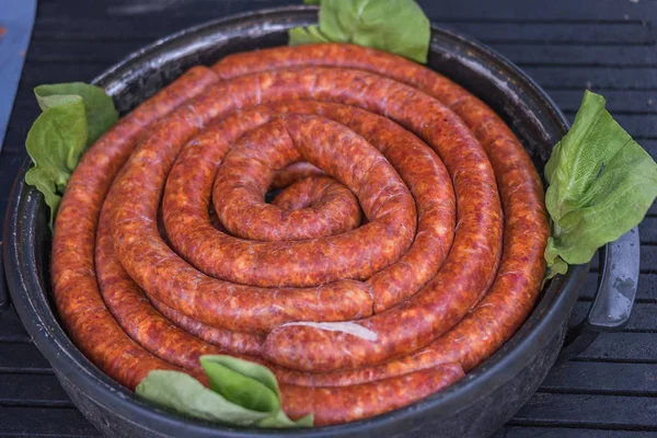 Sausages in a cooker with green salad — Stock Photo, Image
