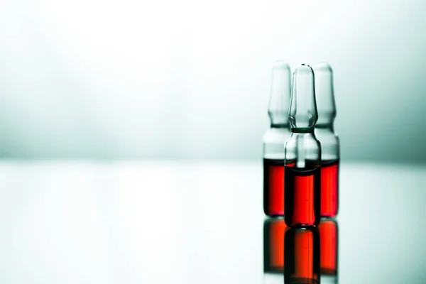 Group of ampoules with a transparent medicine in medical laborat — Stock Photo, Image