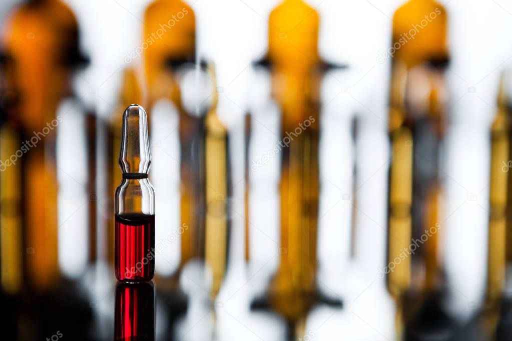 Group of ampoules with a transparent medicine in medical laborat