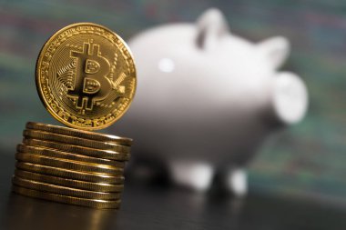 Bir altın bitcoin jeton ile beyaz piggy banka