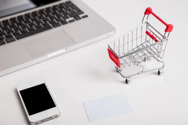 Online shopping. Shopping cart, keyboard, bank card