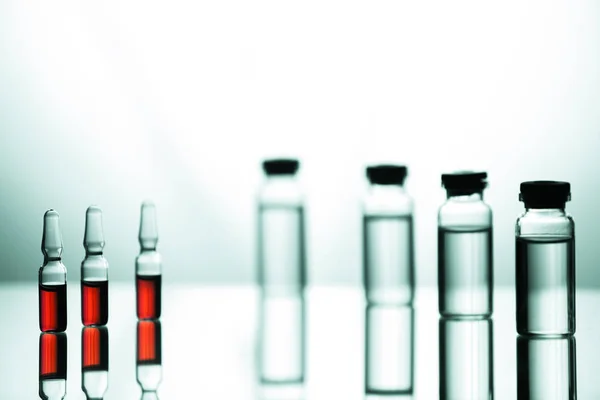 Grupo de ampolas com um medicamento transparente em laboratório médico — Fotografia de Stock
