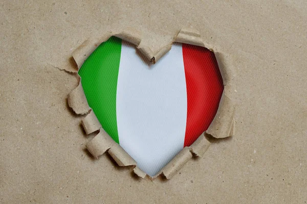 Heart Shaped Hole Torn Paper Showing Italian Flag — 스톡 사진