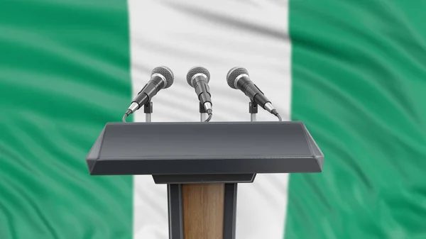 Podium lectern with microphones and Nigerian flag in background