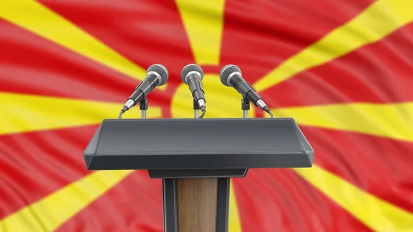 Podium lectern with microphones and Macedonian Flag in background