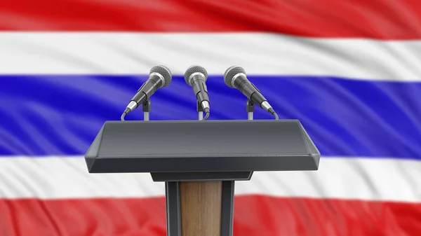 Podium lectern with microphones and Thai flag in background