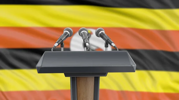 Podium lectern with microphones and Uganda flag in background