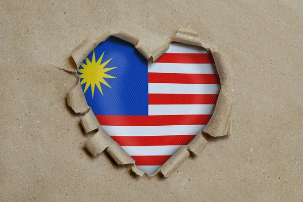 Heart Shaped Hole Torn Paper Showing Malaysia Flag — Stock Photo, Image