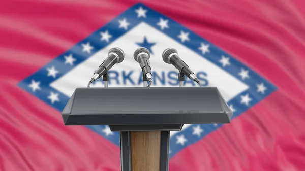 Podium lectern with microphones and Arkansas flag in background