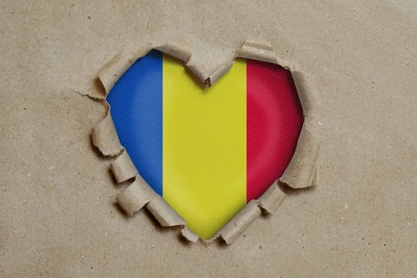 Heart Shaped Hole Torn Paper Showing Romanian Flag — Stock Photo, Image