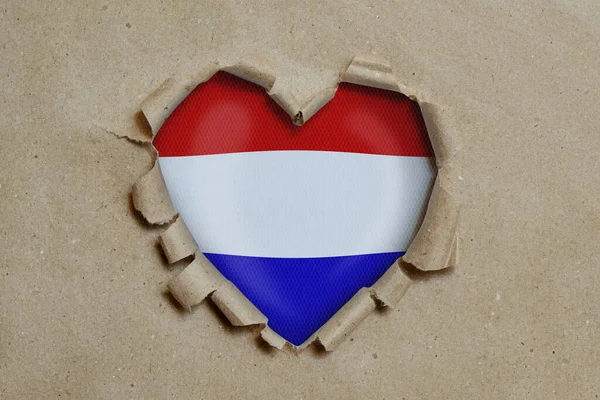 Hjärtformade Hål Slits Genom Papper Visar Nederländernas Flagga — Stockfoto