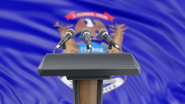 Podium lectern with microphones and Michigan flag in background