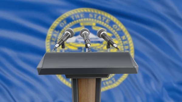 Podium lectern with microphones and Nebraska flag in background